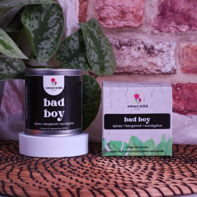 Sweet Wild Large Scented Candle Tin - Bad Boy - The "Bad Boy" candle is not just a fragrance; it's an experience. Capturing the essence of daring and charismatic energy, this candle brings forth the adventurous spirit within you. Whether you're treating yourself o a loved one, the "Bad Boy" candle is the perfect choice to make every moment special.

This plant-based candle is profoundly stimulating and utterly captivating. Citrusy bergamot, lemon leaf, and spices mark the opening notes, reinforced with revitalizing eucalyptus, soothing lavender, and cheerful geranium. It's seductively complemented by red cedarwood, massoia wood, ambergris, frankincense, and musk.

Top notes: Bergamot, Lemon Leaf, Eucalyptus
Heart notes: Spices, Lavender, Geranium
Base notes: Cedarwood, Massoia, Woods, Amber

240gr - Approximately 50 hours burn.

Coconut and Rapessed wax with Wood Wick in small batches.T his wax is  the best on the market?

Vegan

Free from additives, beeswax, palm, or soy.

Burns cleaner and longer than other wax.

Throws scent extremely well.