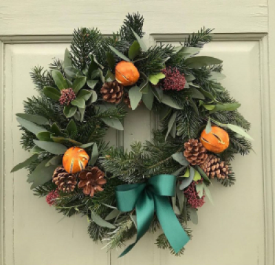 Fresh Spruce, Pine and Eucalyptus door Wreath - Hand Made with spruce and fresh foliage such as eucalyptus, and more  on moss base, with cinnamon sticks, dried fruit, and pine cones, adorned with a bow

The standard size is 16" round.
Medium Size is a 20" wide Heart shaped wreath.
You can choose the colour of the ribbon bow  in your comments when you order. We can also add matching baubles and colour accents on request to personalize your order  or gift.