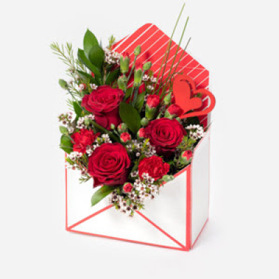 Love Letter - Send a message straight from your heart with this delightful envelope arrangement of romantic flowers. Features red roses, Gemini  and red or pink carnations

Also available with a full sized box of giftwrapped Thorntons Chocolates for a really sweet gift.